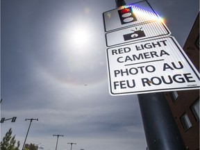 Red light cameras and signs pointing out the cameras along King Edward Saturday June 4, 2016.