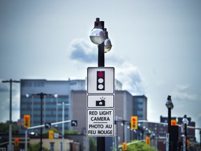 Red light cameras and signs pointing out the cameras along King Edward Saturday June 4, 2016.   Ashley Fraser