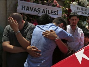 Relatives mourn as they gather around the Turkish flag-draped coffin of Habibullah Sefer, one of the victims killed Tuesday at the blasts in Istanbul's Ataturk airport, during the funeral in Istanbul, Thursday, June 30, 2016. Suicide attackers killed dozens and wounded scores of others at the busy airport late Tuesday, the latest in a series of bombings to strike Turkey in recent months. Turkish authorities have banned distribution of images relating to the Ataturk airport attack within Turkey.