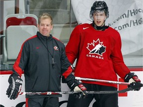 Ryan Nugent-Hopkins, right, from Burnaby, B.C., stands with assistant coach Mario Duhamel during the National Junior hockey team selection camp in Calgary, Alta., Tuesday, Dec. 11, 2012.
