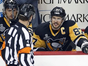 Pittsburgh Penguins captain Sidney Crosby, right, speaks to official Wes McCauley during the first period in Game 2 of the NHL hockey Stanley Cup finals between the Penguins and the San Jose Sharks on Wednesday, June 1, 2016, in Pittsburgh.