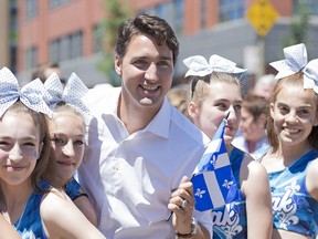 Liberal Leader Justin Trudeau poses for photograph with young participants at the annual St-Jean-Baptiste Day parade in Montreal, Wednesday, June 24, 2015. THE CANADIAN PRESS/Graham Hughes  0625 na trudeau