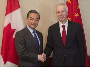Canada's Minister of Foreign Affairs Stephane Dion, right, meets with Chinese Foreign Minister Wang Yi on Parliament Hill in Ottawa, Wednesday June 1, 2016.