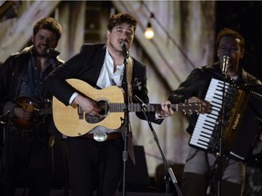 Musicians Winston Marshall, Marcus Mumford, and Ben Lovett of Mumford and Sons perform at the Grammys in 2013. They play the Canadian Tire Centre on Sunday, June 12.