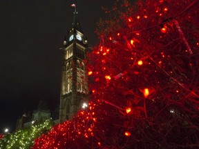 The Peace Tower on Parliament Hill is seen among lights after the launch of Christmas Lights Across Canada on Parliament Hill in Ottawa on Wednesday, Dec. 2, 2015.