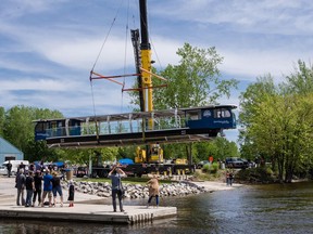 The Queen Elizabeth, a 100 per cent electric vessel to be operated by Rideau Canal Cruises this spring and summer, is lowered into the water of the Gatineau River for the first time for testing. (Errol McGihon/Postmedia)