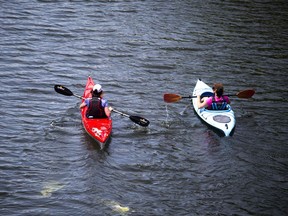 Two paddlers enjoy the Rideau Canal.