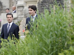Canadian Prime Minister Justin Trudeau, right, and Mexican President Enrique Pena Nieto talk as they walk to a dinner at Casa Loma in Toronto on Monday, June 27, 2016.