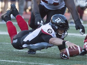 Ottawa Redblacks quarterback Trevor Harris recovers a ball he fumbled under pressure from the Montreal Alouettes during first quarter CFL football action, in Montreal on Thursday, June 30, 2016. The Redblacks dusted themselves off and went on to win their second of the season.