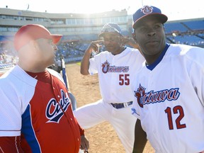 Two Cuban players from the Ottawa Champions, Alexander Malleta, centre, and Donal Duarte chat with Cuban national team manager Roger Machado before the game on Friday, June 17, 2016.