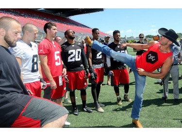 UFC fighter, Donald Cerrone (right) demonstrates a good kick to some players.