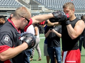 UFC fighter, Misha Cirkunov, left) shows a Redblack how to punch.