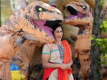 Visiting from India, Vindhya (centre) didn't quite know what to make of the roving pack of dines, but got a few pictures all the same.  Dinosaurs seemed to be taking over in downtown Ottawa as a pack of large, wobbling meat eaters wandered around the Byward Market Tuesday (June14, 2016).  The dinos, which took some by surprise, but mostly gave people a pretty cool selfie, were out to promote the Ultimate Dinosaurs exhibit, which runs at  the Canadian Museum of Nature from June 11 to Sept. 5th. JULIE OLIVER/POSTMEDIA