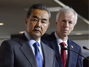 China's Minister of Foreign Affairs Wang Yi (left) and Canada's Minister of Foreign Affairs Stephane Dion participate in a press conference on Wednesday, June 1, 2016 in Ottawa.