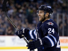 Winnipeg Jets' Grant Clitsome (24) celebrates after scoring a second period goal against the San Jose Sharks' during NHL hockey action in Winnipeg, Sunday, November 10, 2013.