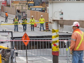 Workers get a close-up look as Ottawa deals with the massive sinkhole on Rideau Street.