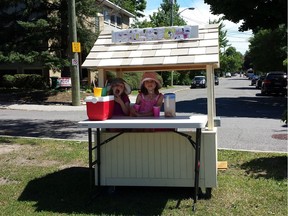 Eliza, 7, and Adela, 5, at their lemonade stand on the median facing Echo Drive. Suddenly, we're thirsty.
