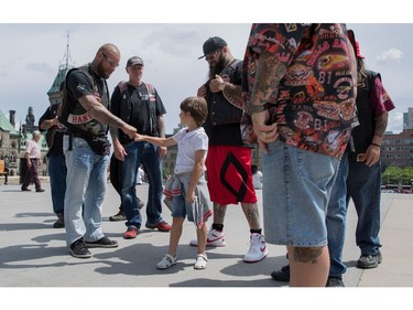 Six-year-old Vladimir, gets a fist-pump from Hells Angels on Parliament Hill July 23, 2016.