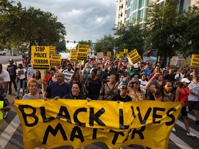 A Black Lives Matter protest, held in response to the deaths of Alton Sterling and Philando Castile, takes place in downtown Tampa on Monday, July 11, 2016. Both Sterling and Castile were shot by police officers the prior week. (Loren Elliott/Tampa Bay Times via AP)  ORG XMIT: FLPET203