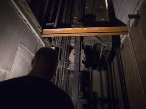 A building manager is pictured in an elevator pit in a downtown Toronto office building on Wednesday July 13, 2016.