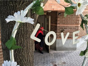 A woman walks out of 55 Hilda St., Tuesday July 26, 2016, where Abdirahman Abdi suffered severe injuries while being arrested by Ottawa Police Sunday. Abdi died on Monday afternoon, a day after a confrontation between him and police prompted a Special Investigations Unit probe into how the 37-year-old Somali-Canadian man suffered fatal injuries during his arrest. (Darren Brown/Postmedia)