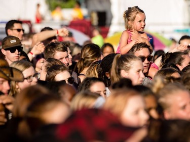 A young girl watches Alessia Cara perform on the City Stage.