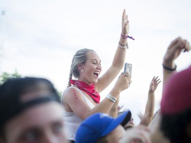 A young woman on the shoulders of a friend during Schoolboy Q at Bluesfest Thursday July 7, 2016.