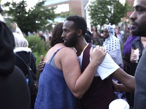 Abdiaziz Abdi, brother of Abdirahman Abdi, who died after an altercation with Ottawa Police officers Sunday, is embraced during a memorial for his brother on Tuesday, July 26, 2016 in Ottawa.