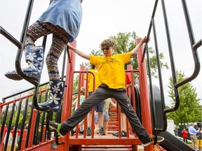 Aiden Derouchie, center, plays on the new Ontario section of the Canada-themed Giver 150 Mooney's Bay Park Thursday, July 14, 2016. (