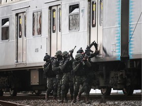 Brazilian soldiers conduct a counterterrorism drill simulating an attack at the Deodoro train station on July 16, 2016 in Rio de Janeiro, Brazil. Brazil announced yesterday it was bolstering security for the Rio 2016 Olympic Games following the truck attack in Nice, France.