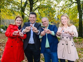 Nick Xenophon (2nd L), leader of the Nick Xenophon Team political party, and his team candidates Rebekha Sharkie (L), Skye Kakoschke-Moore (R) and Stirling Griff (2nd L) pose for photographs in the Adelaide Hills town of Stirling on July 3, 2016. Australia was in political limbo on July 3 after voters failed to hand Prime Minister Malcolm Turnbull the stability he craved in calling an election, with the nation instead facing the prospect of a hung parliament. Xenophon, recently established his own party which has secured a seat through candidate Rebekha Sharkie. /