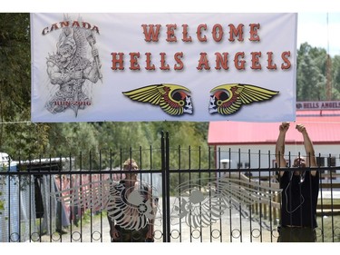 Bikers hang up a banner outside the Hells Angels Nomads compound before the group's Canada Run event on Friday, July 22, 2016, in Carlsbad Springs, Ont., near Ottawa.
