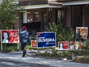 Campaign signs dot lawns in the Toronto riding of Davenport on federal election day, Oct. 19, 2015. How should we consult Canadians about potential changes to the way we vote in future?