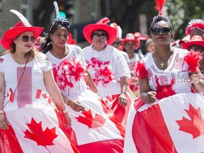 Participants entertain the crowd during the annual Canada Day parade in Montreal, Friday, July 1, 2016.