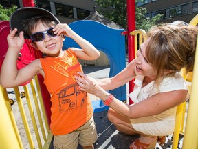 Carmen Perron, seen with Noah Marois, 3, is the director of a daycare that was at risk of closing but has now received a lifeline from the government in the form of a rent freeze until 2019.