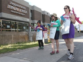 Childcare workers walk the picket line at the YMCA in Argyle Ave in Ottawa Tuesday July 12, 2016. Dozens of childcare workers at two YMCA locations and an east Ottawa public school are officially on strike after going one year without a contract, leaving more than 200 children without daycare.