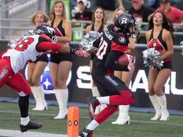 Chris Williams runs for a touchdown with Brandon Smith of Calgary in pursuit in the first quarter.