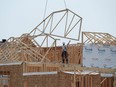 Construction workers build new homes.