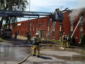 Firefighters battle a blaze at a woodworking business in Nepean.