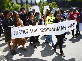 Demonstrators march from Somerset Square Park to Ottawa police headquarters on Elgin Street during the March for Justice - In Memory of Abdirahman Abdi. Saturday, July 30, 2016.