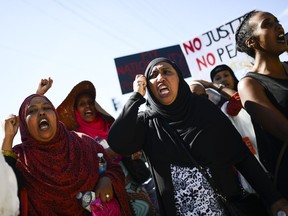 Demonstrators march from Somerset Square Park to Ottawa police headquarters on Elgin Street during the March for Justice - In Memory of Abdirahman Abdi.