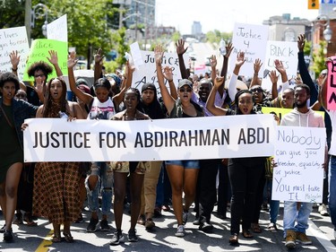 Demonstrators march from Somerset Square Park to Ottawa police headquarters on Elgin Street during the March for Justice - In Memory of Abdirahman Abdi. Saturday, July 30, 2016.