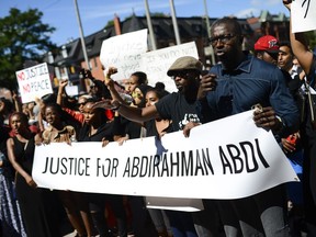 Demonstrators shout and chant for justice as they arrive at Ottawa police headquarters during the March for Justice - In Memory of Abdirahman Abdi. Saturday, July 30, 2016.
