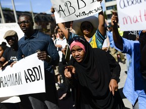 Demonstrators shout and chant for justice as they arrive at Ottawa police headquarters during the March for Justice - In Memory of Abdirahman Abdi on Saturday.