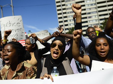 Demonstrators shout and chant for justice as they arrive at Ottawa police headquarters during the March for Justice - In Memory of Abdirahman Abdi. Saturday, July 30, 2016.