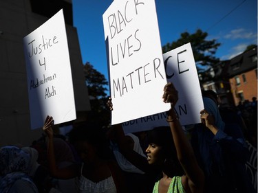 Demonstrators shout and chant for justice as they arrive at Ottawa police headquarters during the March for Justice - In Memory of Abdirahman Abdi. Saturday, July 30, 2016.