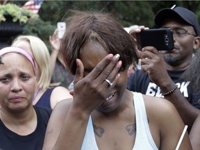 Diamond Reynolds, the girlfriend of Philando Castile of St. Paul, cries outside the governor's residence in St. Paul, Minn., on Thursday, July 7, 2016.  Castile was shot and killed after a traffic stop by police in Falcon Heights, Wednesday night. A video shot by Reynolds of the shooting  went viral.