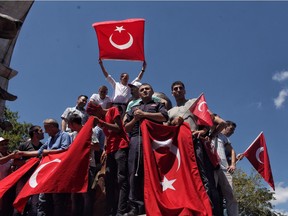 ISTANBUL, TURKEY - JULY 19: Supporters of Turkish President Recep Tayyip Erdogan wave flags during a rally in Fatih district on July 19, 2016 in Istanbul, Turkey. Clean up operations are continuing in the aftermath of Friday's failed military coup attempt. Latest figures according to Turkey's Prime Minister Binali Yildirim raises the death toll to 232 with 1491 wounded. Continuing raids across the country have seen 9,322 people detained and 316 arrested including high ranking soldiers, judges and police officers.