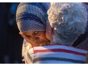 Family friend Nimao Ali is hugged by a friend after speaking at the vigil which took place at Somerset Park on Spadina Ave for Abdirahman Abdi, 37, who passed away from injuries he suffered on Sunday during a confrontation with Ottawa Police.