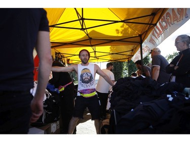 Fans buy t-shirts before the start of the Tragically Hip's Man Machine Poem Tour outside the Save-On-Foods Memorial Centre in Victoria, B.C., Friday, July 22, 2016.